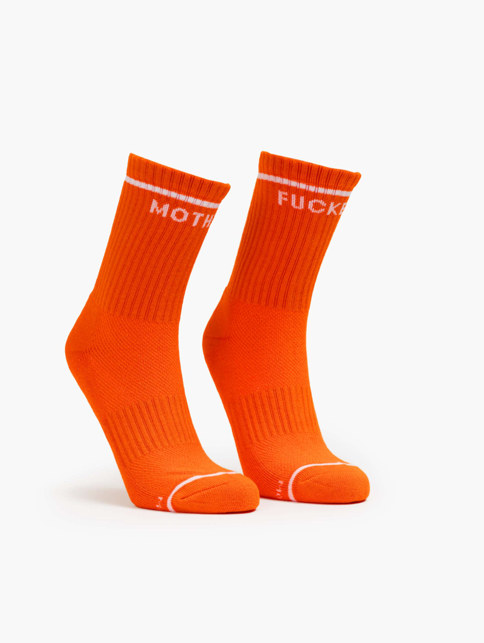Two bright orange "Baby Steps" crew socks from Mother stand upright on a white background. The left sock features "MOTH" and the right sock "FUCK" in white text near the top.
