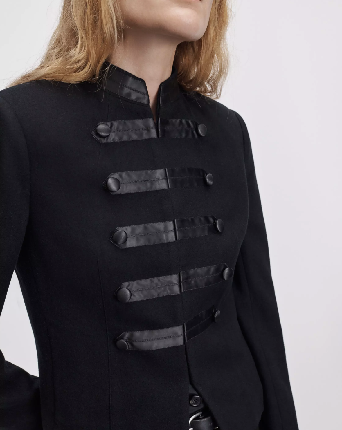 Black blazer with faux leather straps and buttons by Rag &amp; Bone, Mercer Regalia style, shown shoulders up.