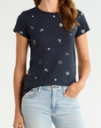 Rag & Bone rodeo graphic tee in white paired with light blue jeans, casual hand-in-pocket look.