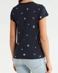 Navy Rag & Bone rodeo tee with white embroidery, styled with light blue jeans, shown from the back.