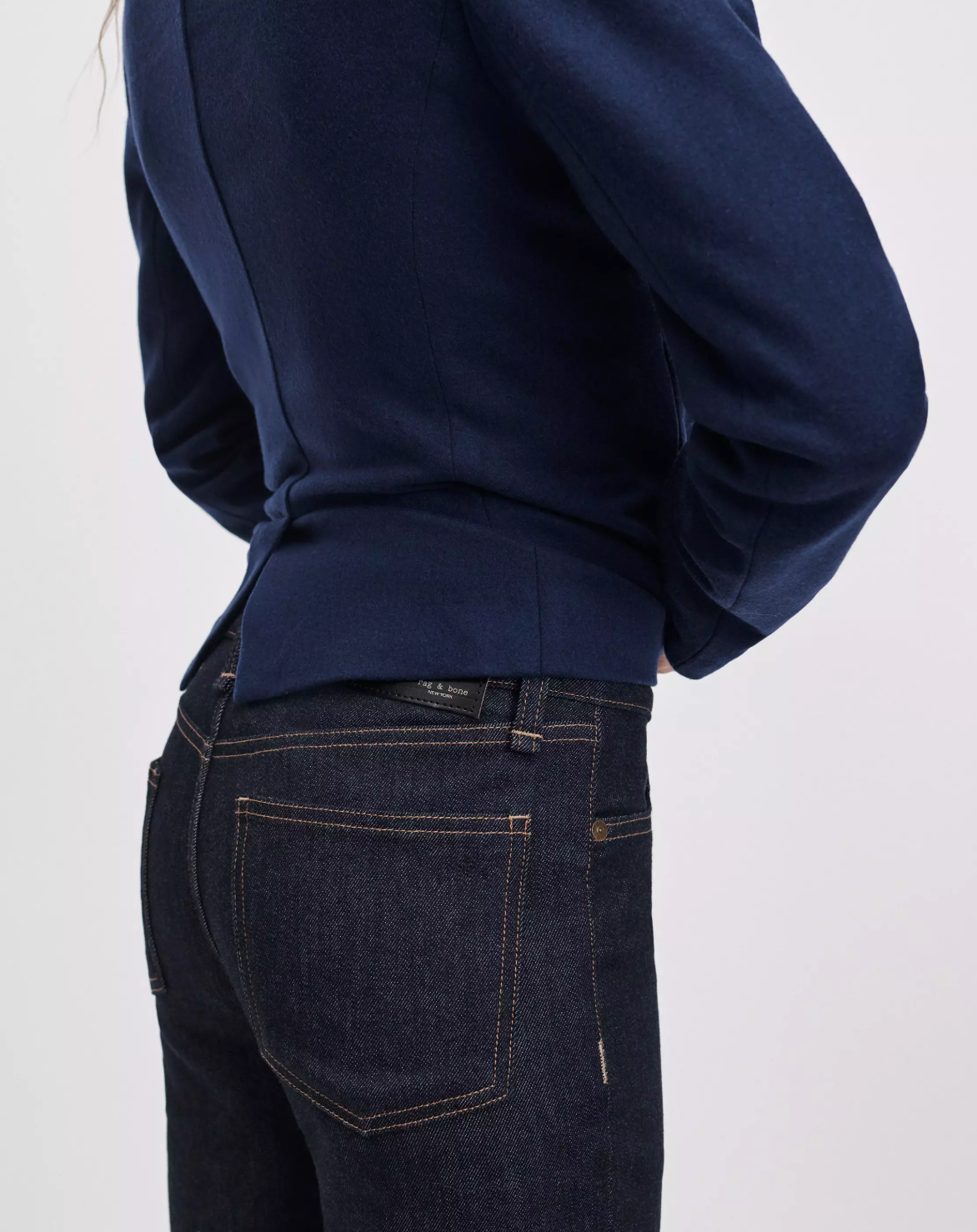 Rag &amp; Bone Sutton Cigarette Jean in blue denim and navy blazer, back view against a light background.