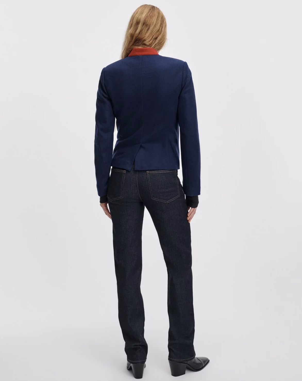 Rag &amp; Bone Sutton Cigarette Jean in blue, styled with a blazer and boots, model shown from the back.