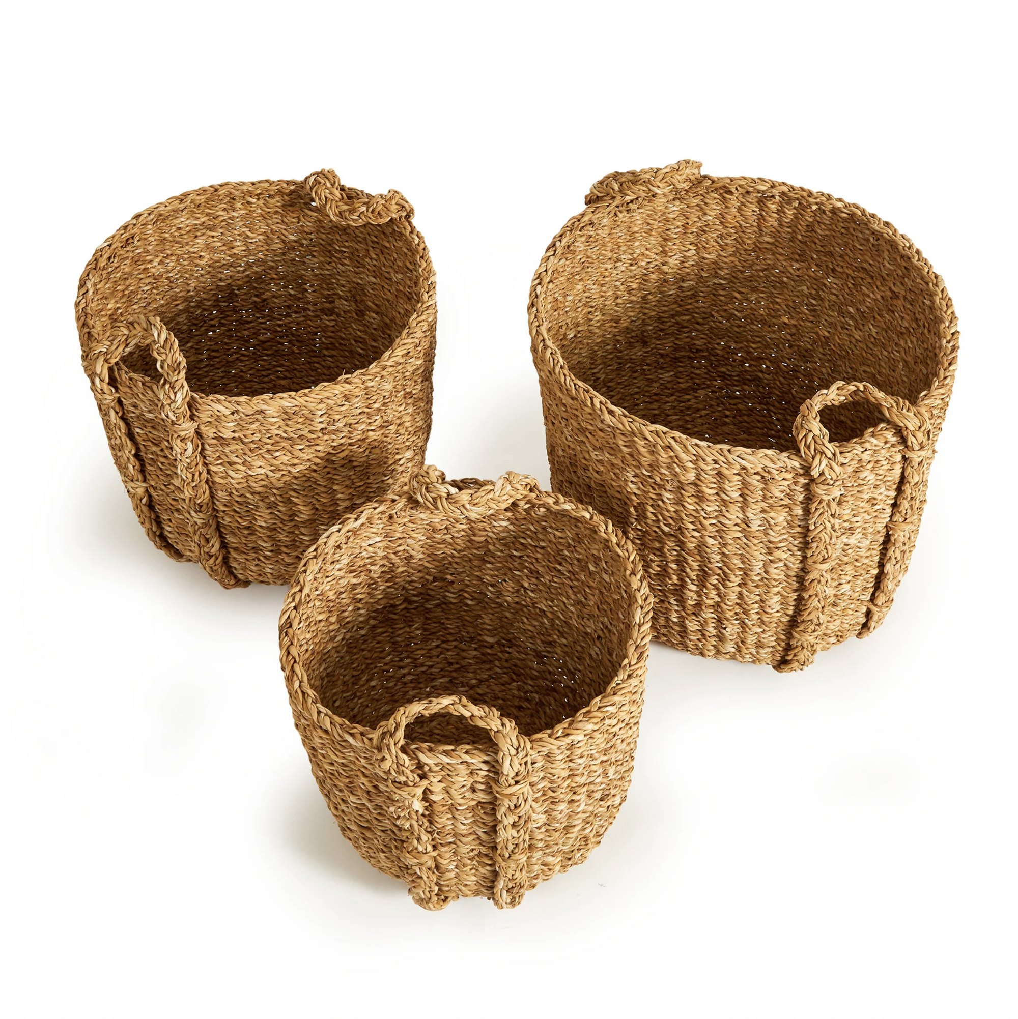 The Napa Home & Garden Seagrass Round Drum Baskets—three natural fiber baskets with loop handles in assorted sizes—offer stylish storage and add a natural touch to any space. Shown arranged on a white background.