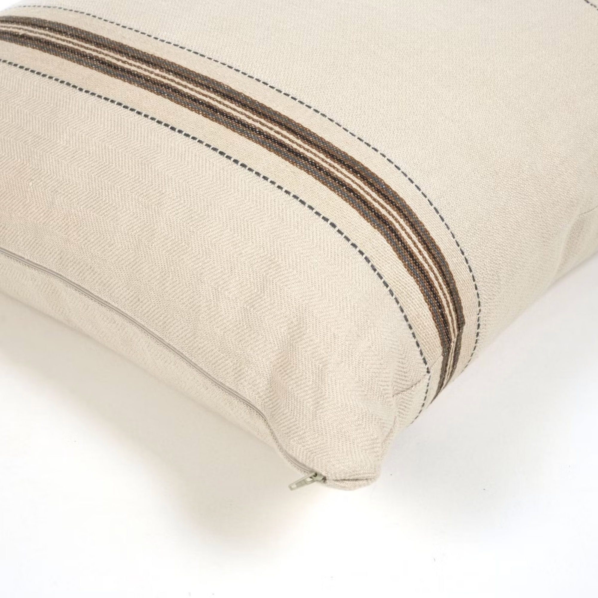 The Vourkari Pillow by Libeco Home is beige with brown and black stripe accents, featuring a visible zipper closure along one edge, shown on a white surface.