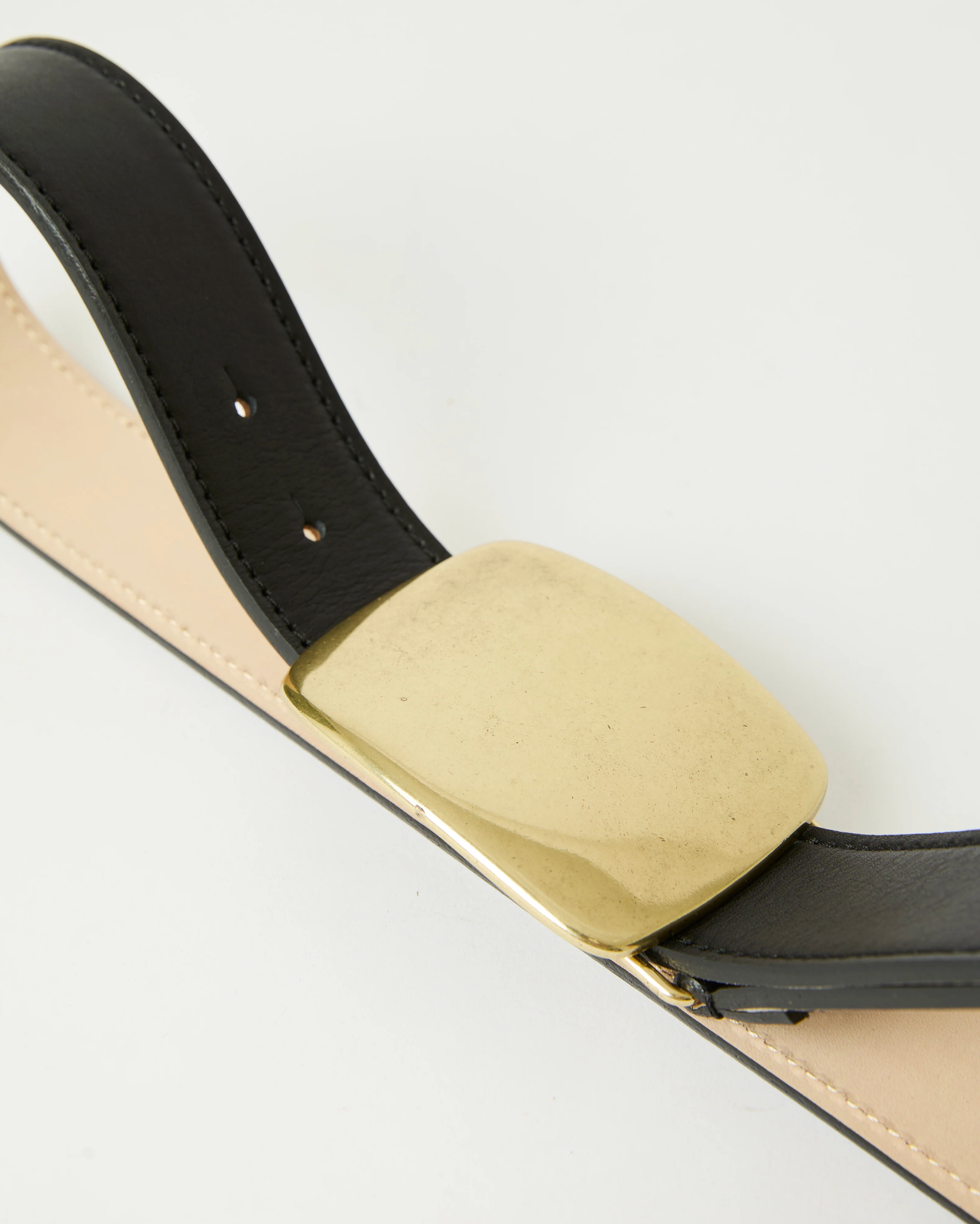 A close-up of the B-Low The Belt Leighton Belt, crafted from genuine black calfskin leather, with a large rectangular Italian-made plaque buckle, shown against a white background.