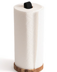 A roll of paper towels stands upright on the Fox Run Brands Acacia PaperTowel Holder, featuring a minimalistic wooden base and a black handle, set against a white background.