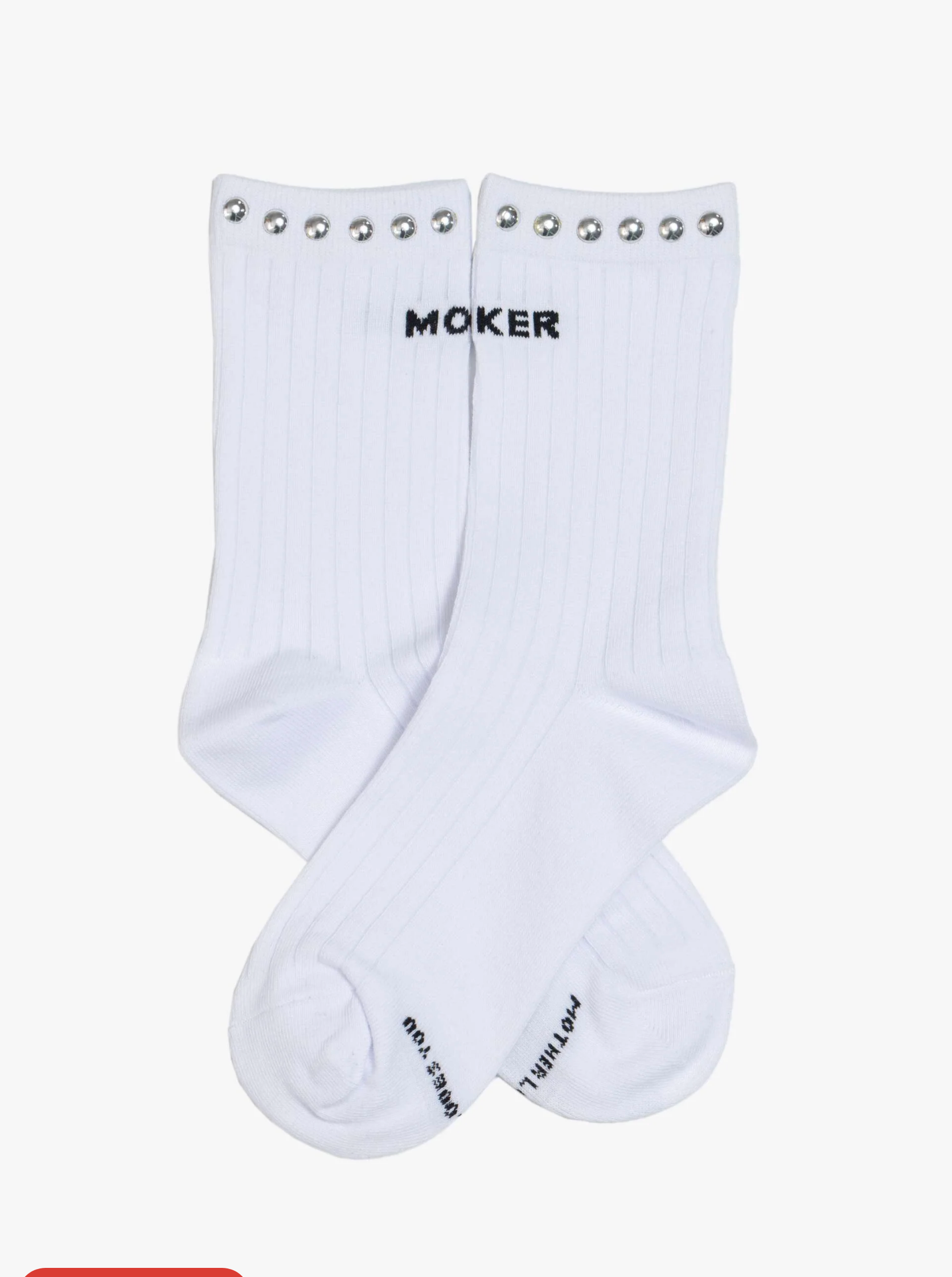 The Half Step by Mother: white ribbed tube socks with metal studs along the top edge and "MOKER" in black near the cuff, crossed and displayed on a plain white background.