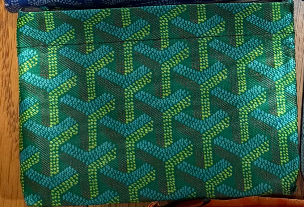 The Faire Reusable Shopping Bags Assorted features a green rectangular design with blue and yellow chevron arrow patterns, shown on a wooden surface.