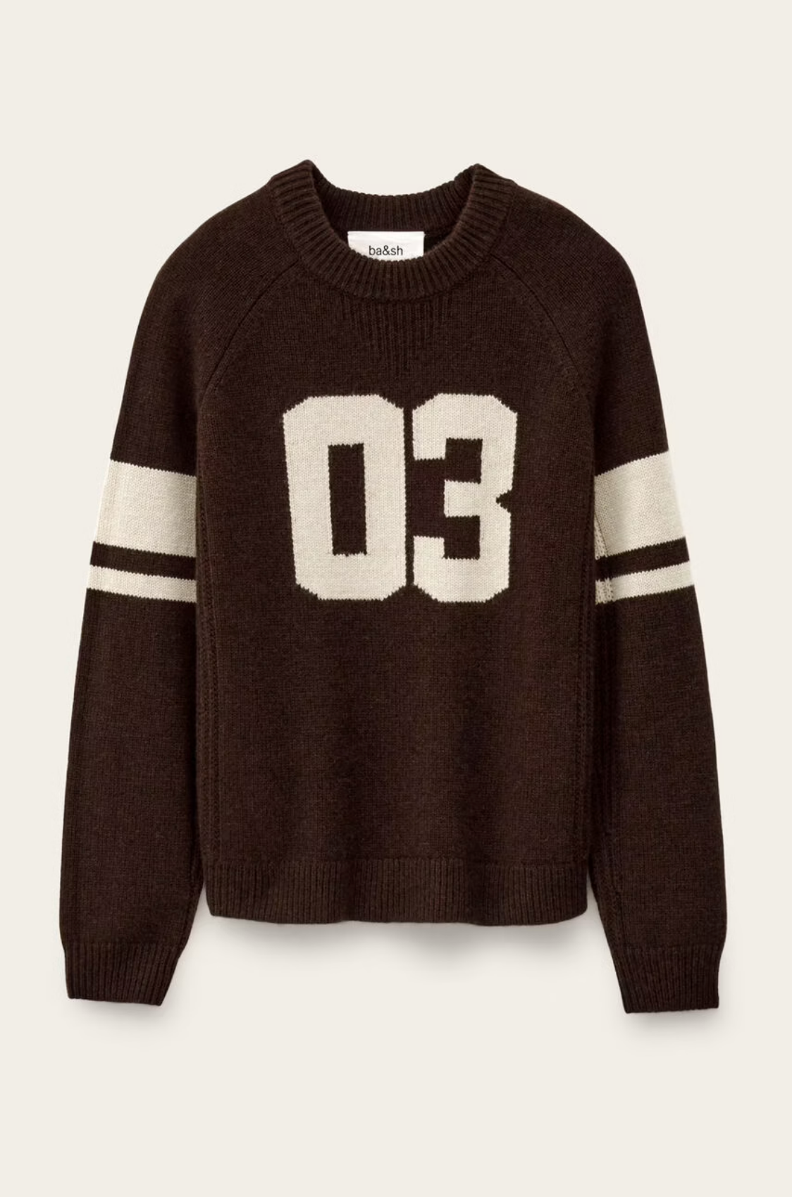 The Jumper Cobe by BA&SH is a dark brown cashmere knit sweater with white sleeve stripes and a bold "03" on the front, shown on a light background. Dry cleaning is recommended to preserve softness and quality.