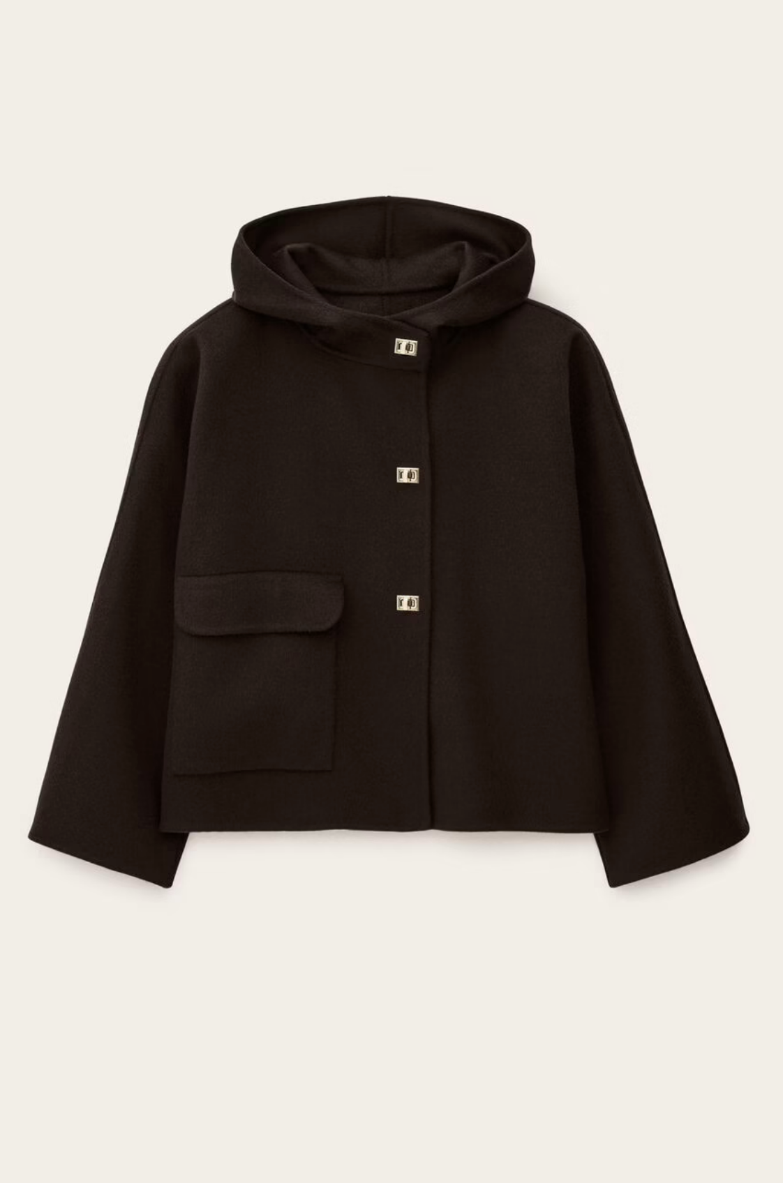 The BA&SH Jacket Kove is a cropped wool coat with a wide collar, long sleeves, a left front flap pocket, and four square gold-tone buttons. Its loose fit and minimal design create a modern, relaxed look.