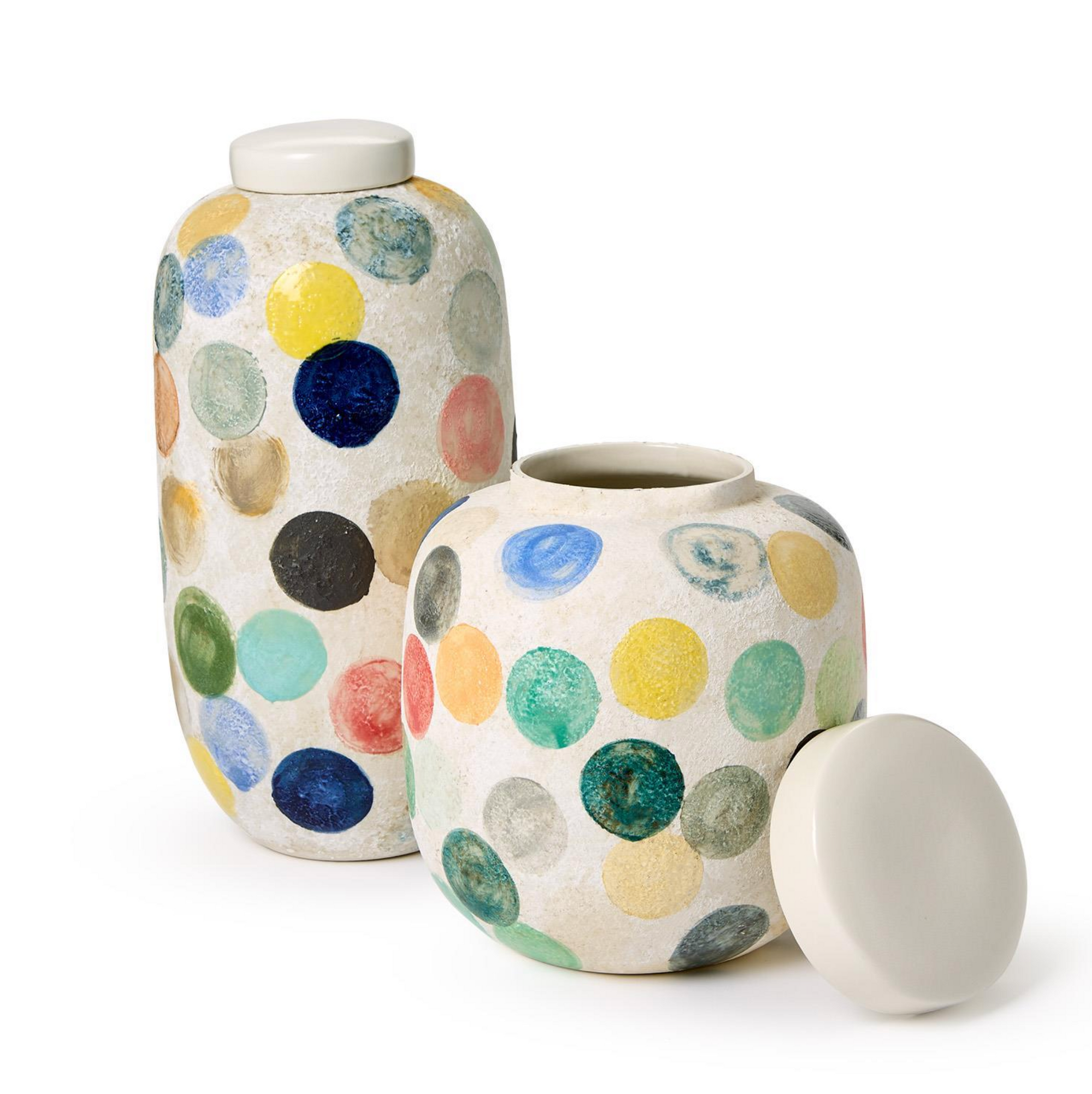 Two's Company Colorful Circle Dot Vases, with off-white lids and vibrant polka dots in blue, green, yellow, orange, and red, sit on a white surface. One vase’s lid is removed and placed beside it.