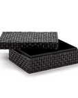 The Rectangle Covered Box by Two's Company features a black, handmade, woven-pattern exterior with a slightly open lid, showcasing its empty interior. Both the box and lid have a textured, basket-like design.