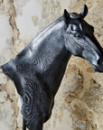 The Horse Bust Sculpture by Two's Company features a textured black finish with faux wood grain, detailed facial features, and a rustic look—perfect for adding character to your home decor against any light background.