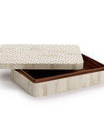 The Studded Covered Box by Two's Company is a rectangular, handmade piece from the Treviso collection, with a cream exterior featuring vertical stripes and gold dots. Its hinged lid is partially open, revealing a brown-lined interior.