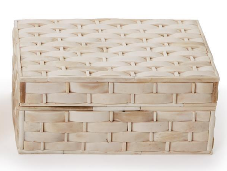 The Basketweave Bone Box by Two's Company features a rectangular, cream-colored design with a fitted lid, smooth uniform texture, and an elegant basket weave pattern.