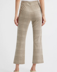 A person stands with their back to the camera in Rag & Bone's irina ponte kick flare pants, featuring a beige and brown plaid pattern, paired with off-white loafers against a plain white background.