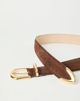 The Marc Belt by B-Low The Belt is a brown suede calfskin hip belt with gold-tone hardware, including a gold buckle and gold-tipped end, shown on a white background.