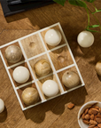 The Tic Tac Toe Game by Two's Company is a hand-crafted mango wood set with light and dark wooden spheres, ideal as unique decor for your game room.