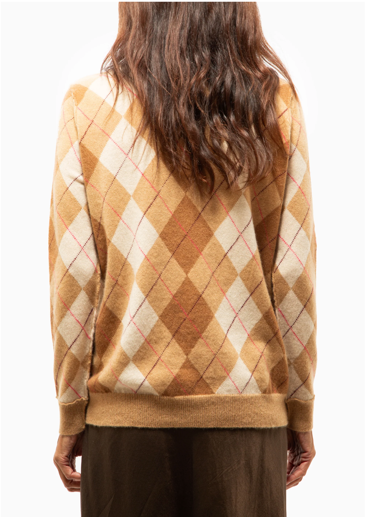 A person with long, wavy brown hair is shown from the back wearing the Brazeau Tricot Argyle Cardigan in brown, beige, and cream, paired with a brown skirt, against a plain white background.