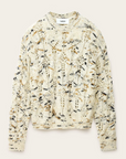 The BA&SH Jumper Rave is a cream, chunky 100% wool sweater with a loose fit and abstract black, brown, and tan speckles. Shown flat on a neutral background. Hand wash or dry clean only.