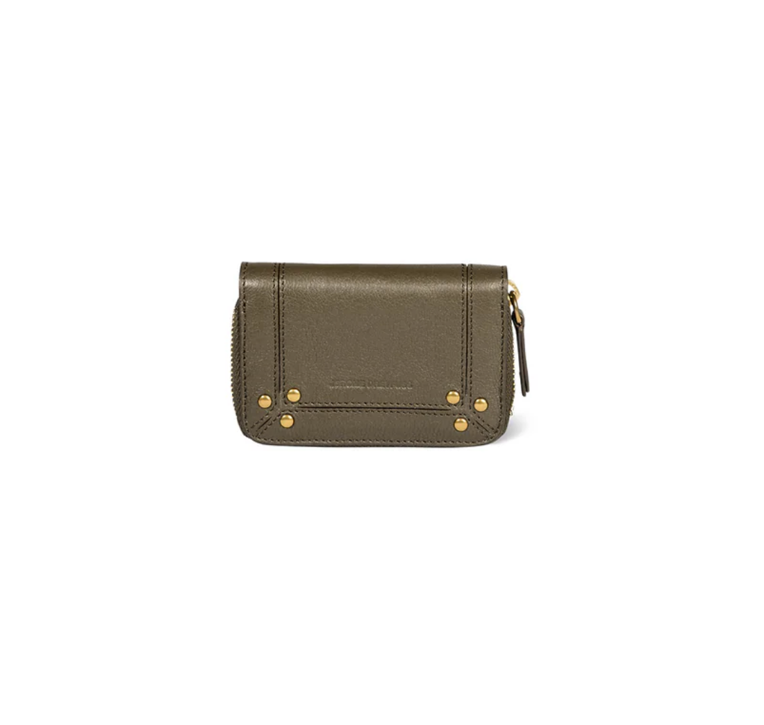 The Henri Zip Wallet by Jerome Dreyfuss is crafted from olive green goatskin leather with gold-tone corner studs, embossed front detailing, and a right-side zipper with a coin compartment, shown against a white background.