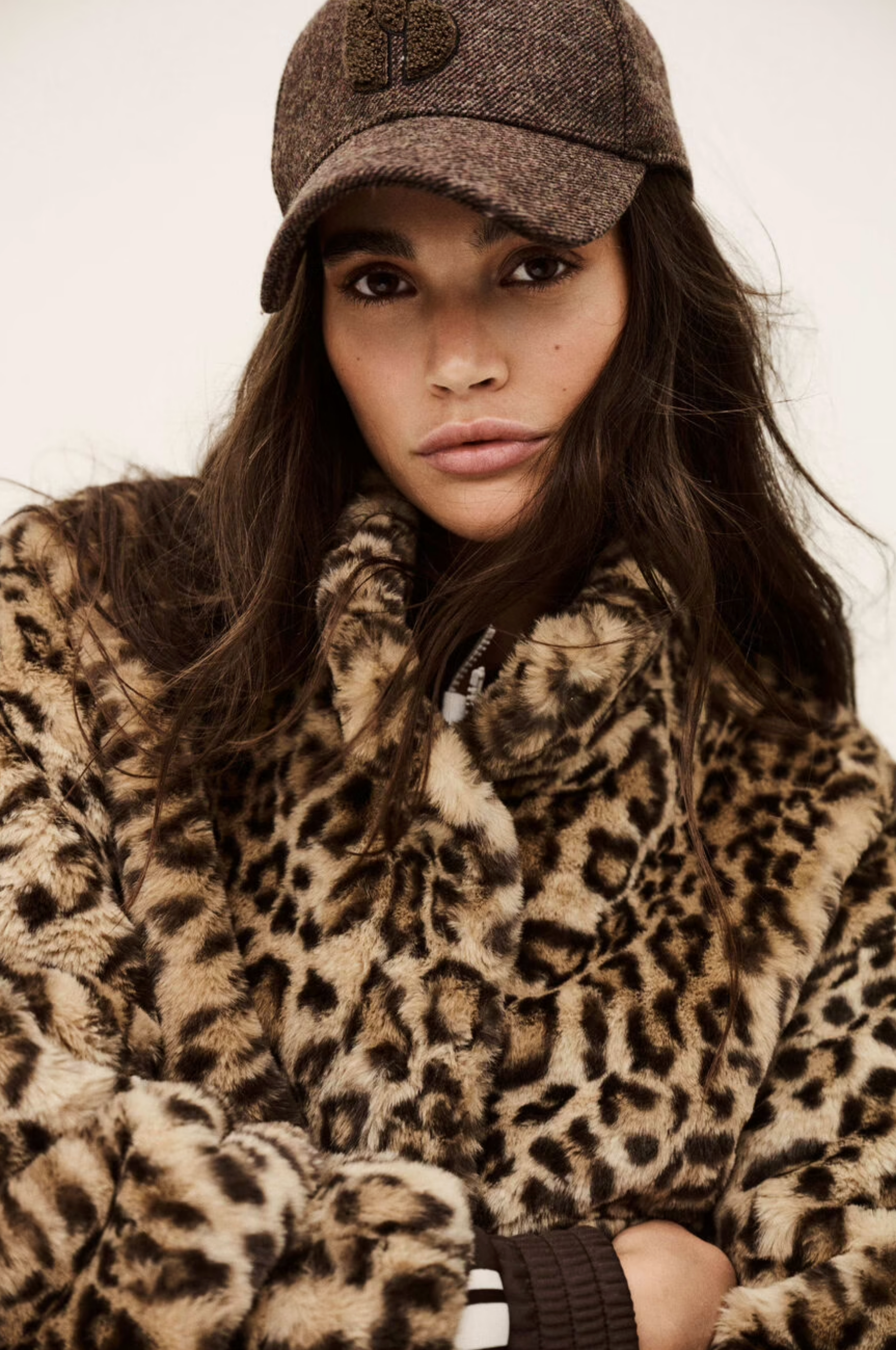 A woman wears the BA&SH Coat Jaros Leopard, crafted from polyester—perfect for stylish outings and labeled dry clean only for effortless care.