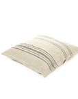 The Moroccan Pillow by Libeco Home is a square beige pillow with subtle black horizontal stripes, crafted from textured fabric and shown on a white background.