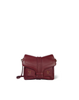 The Harry Handbag by Jerome Dreyfuss is a small burgundy goatskin crossbody with gold-tone stud details, a flap closure, and a thin shoulder strap, shown against a plain white background.
