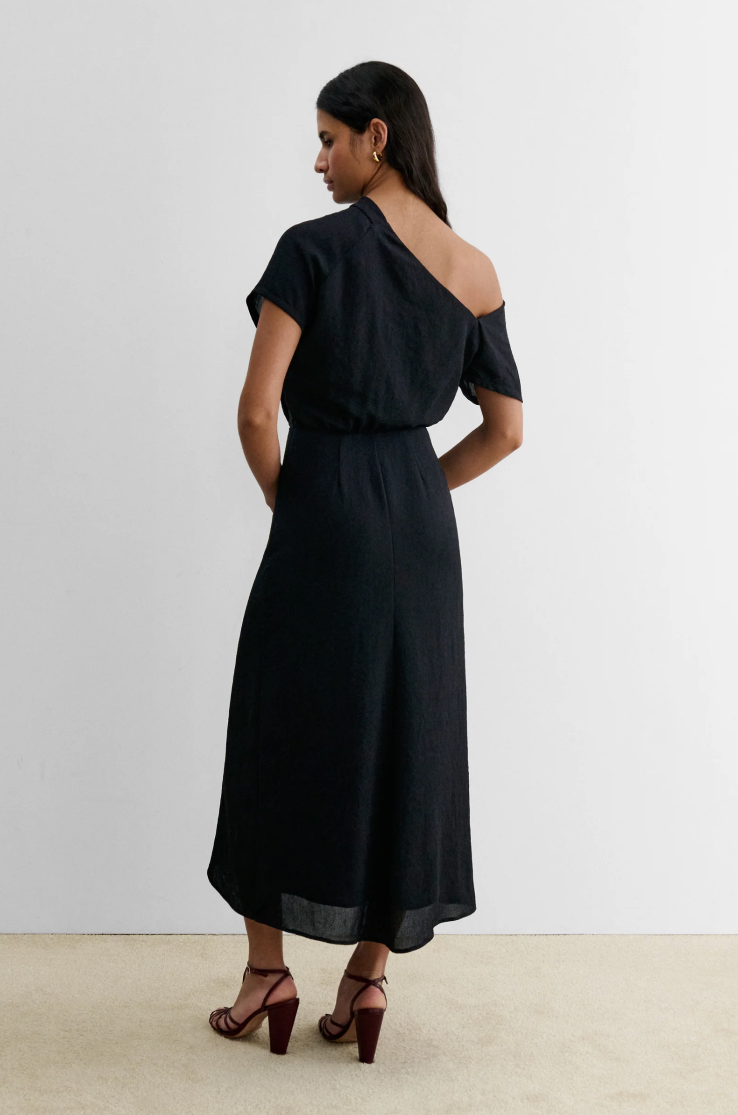Black Rachel Comey Pout Dress styled with maroon heels, shown from the back against a neutral background.