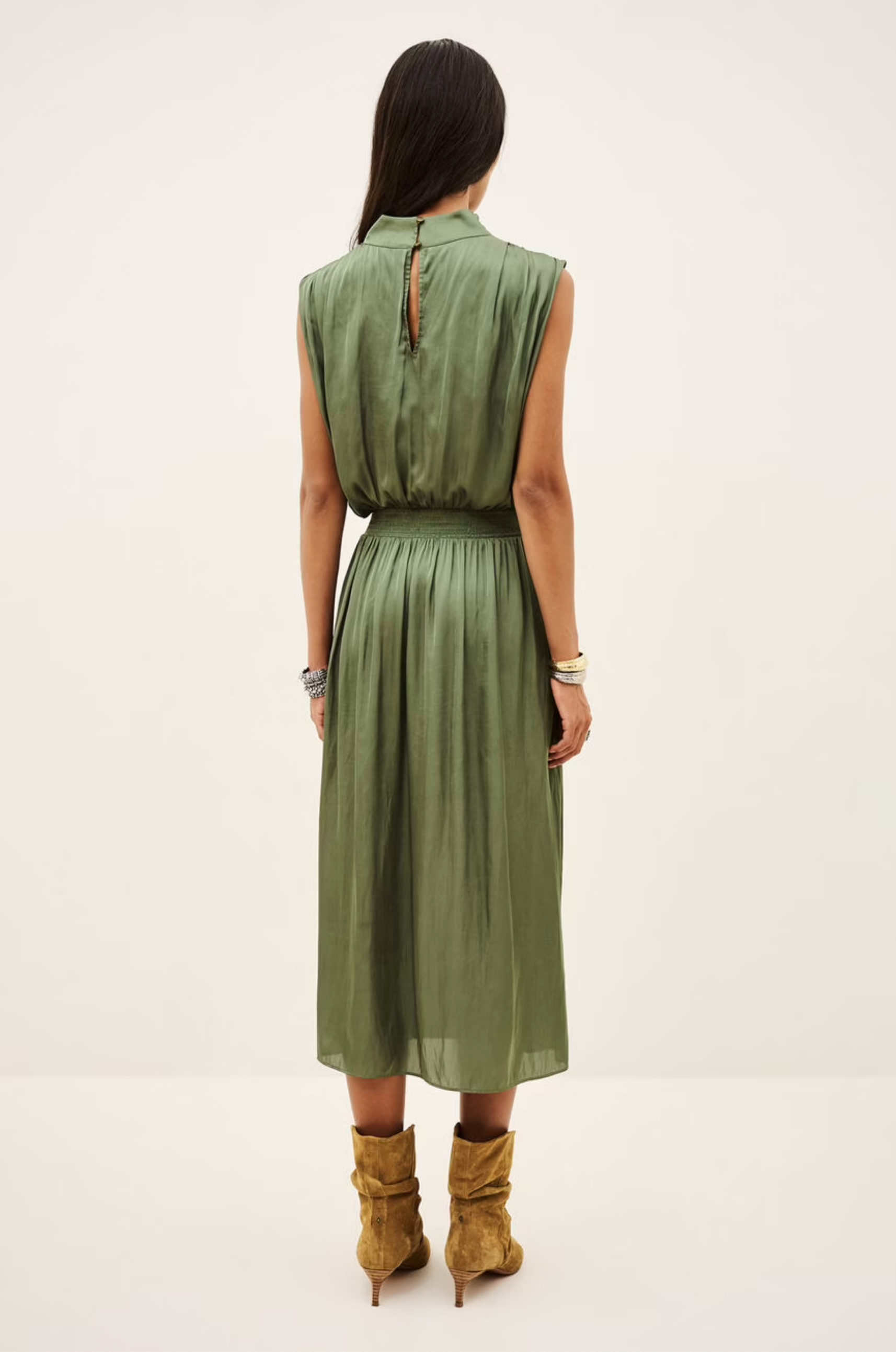 Sleeveless green BA&amp;SH Celea midi dress with draped collar, styled with brown boots at Bungalow Furniture.