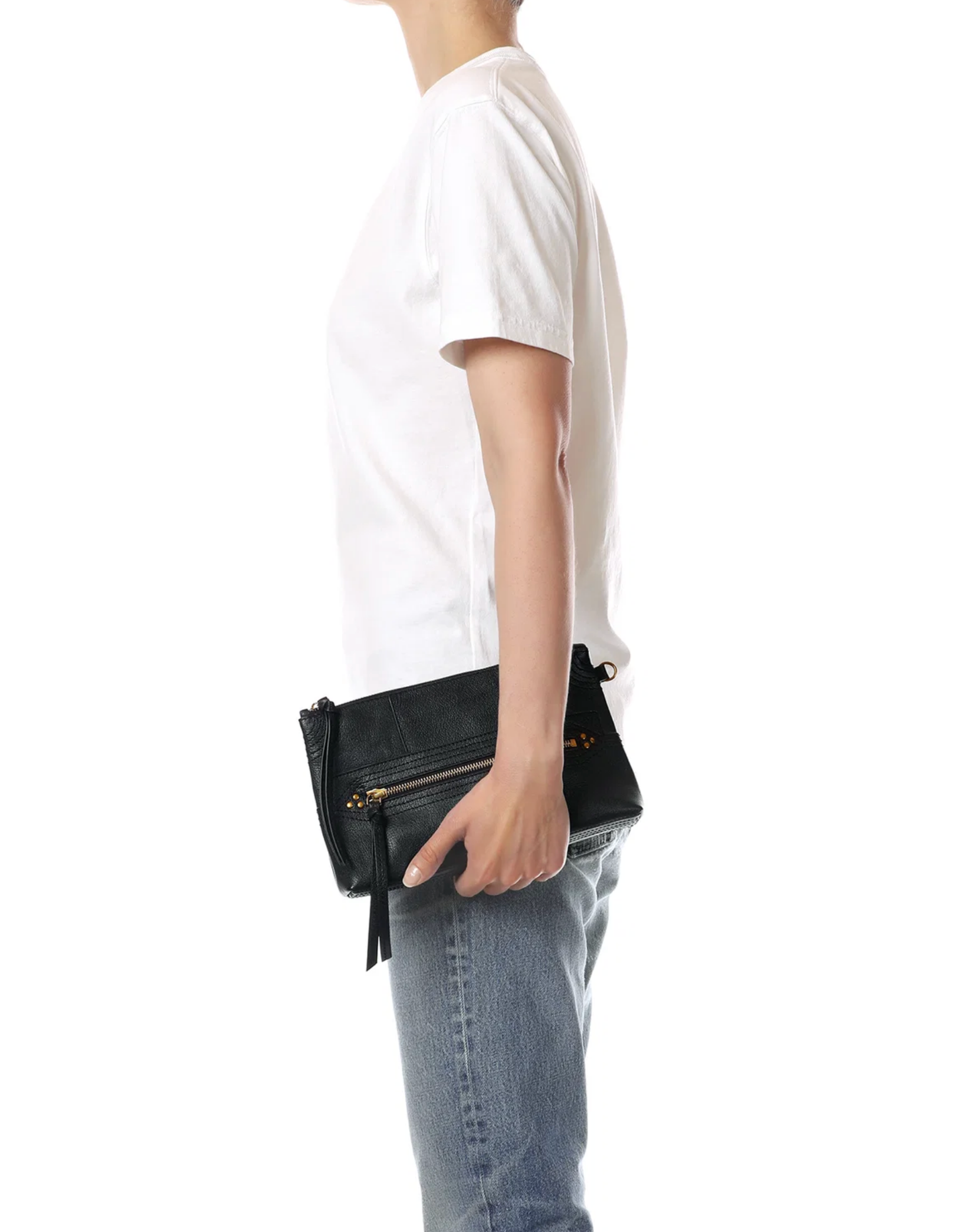 Jerome Dreyfuss Lucky Clutch L with gold zipper, styled with casual white tee and jeans in a modern setting.