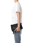 Jerome Dreyfuss Lucky Clutch L with gold zipper, styled with casual white tee and jeans in a modern setting.