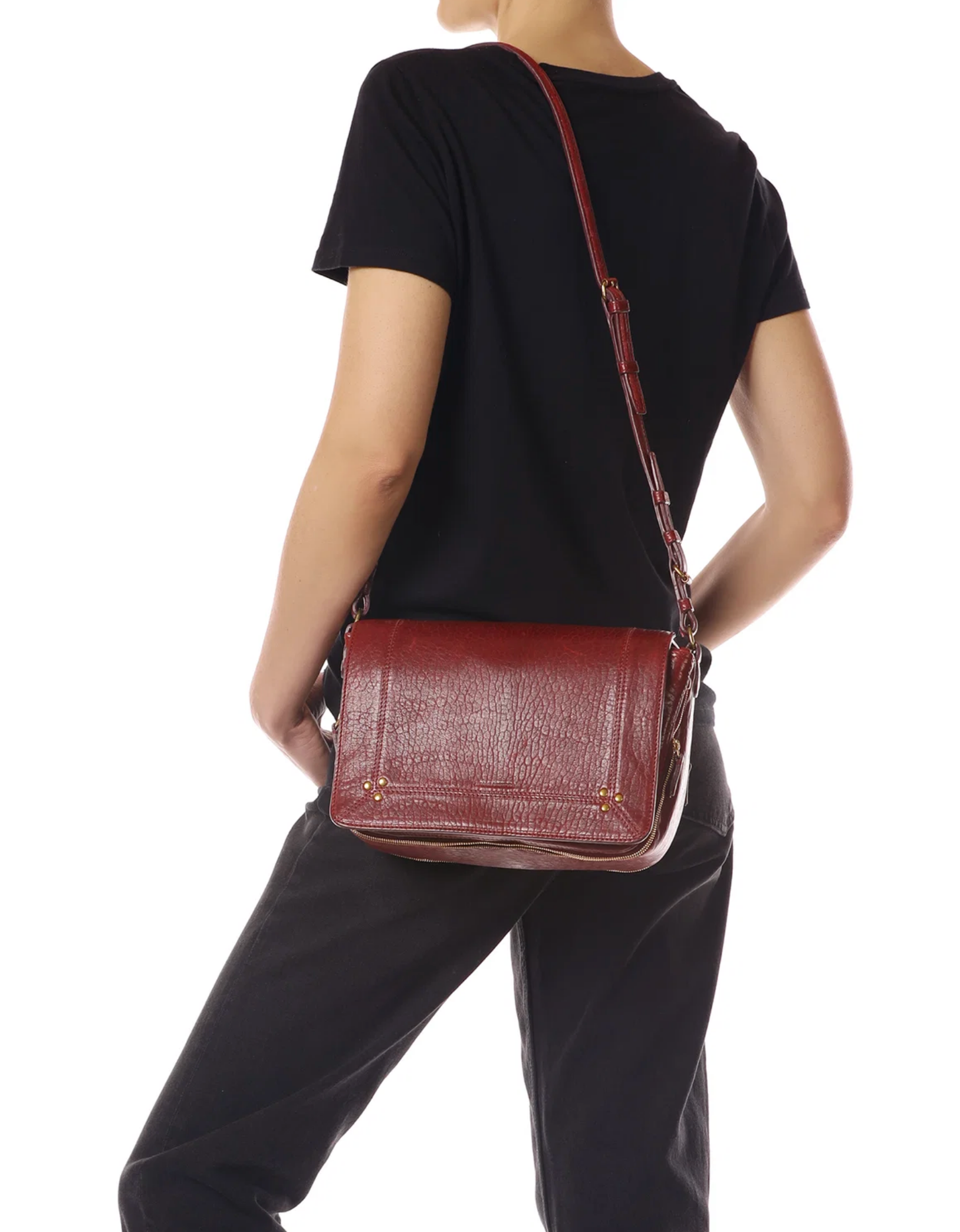 Jerome Dreyfuss Igor red leather shoulder bag with adjustable strap, worn over black clothing.