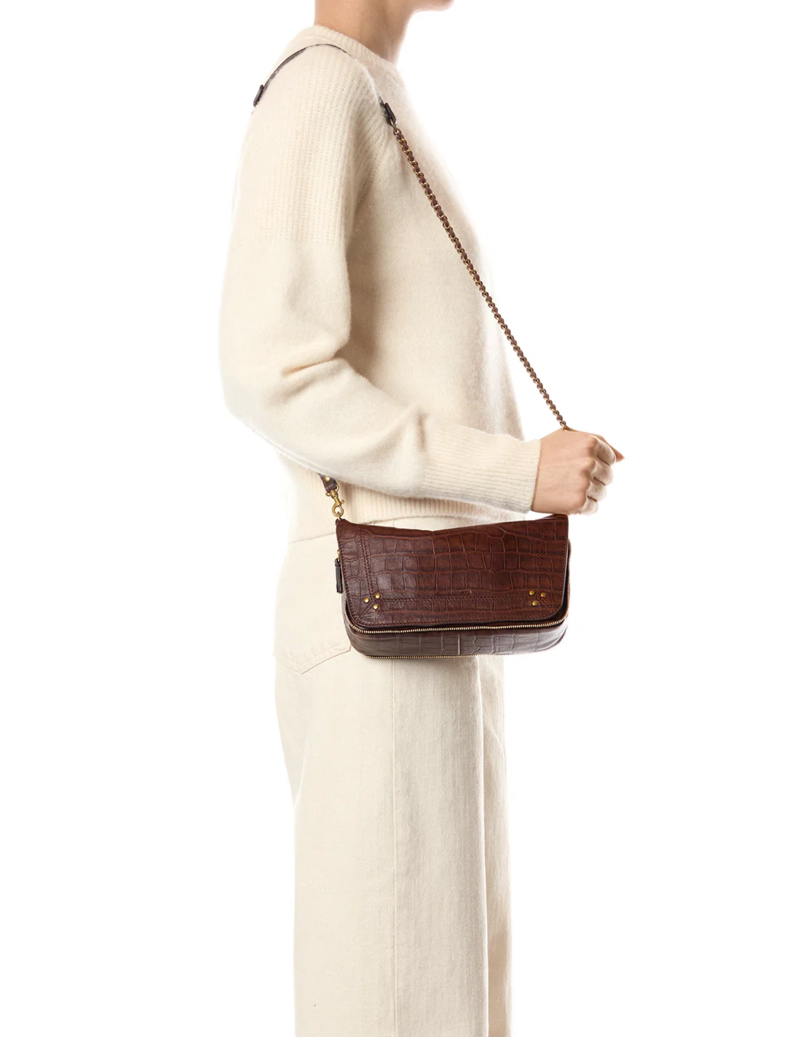 Jerome Dreyfuss Bobi Small Bag in brown with braided leather chain, held by person in an ivory sweater.