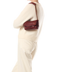 Jerome Dreyfuss Lulu Small Bag styled with a cream sweater and pants against a minimalist white background.