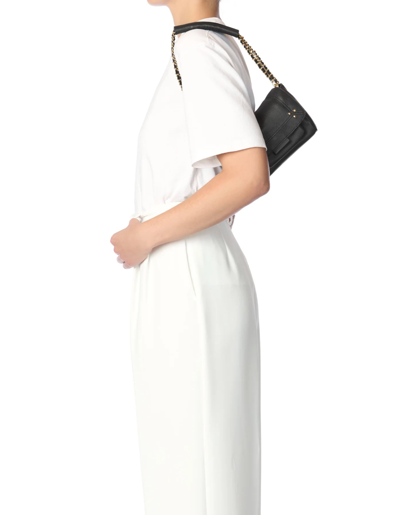 Black Jerome Dreyfuss Lulu Small Bag with gold chain strap, worn by woman in white, side view.