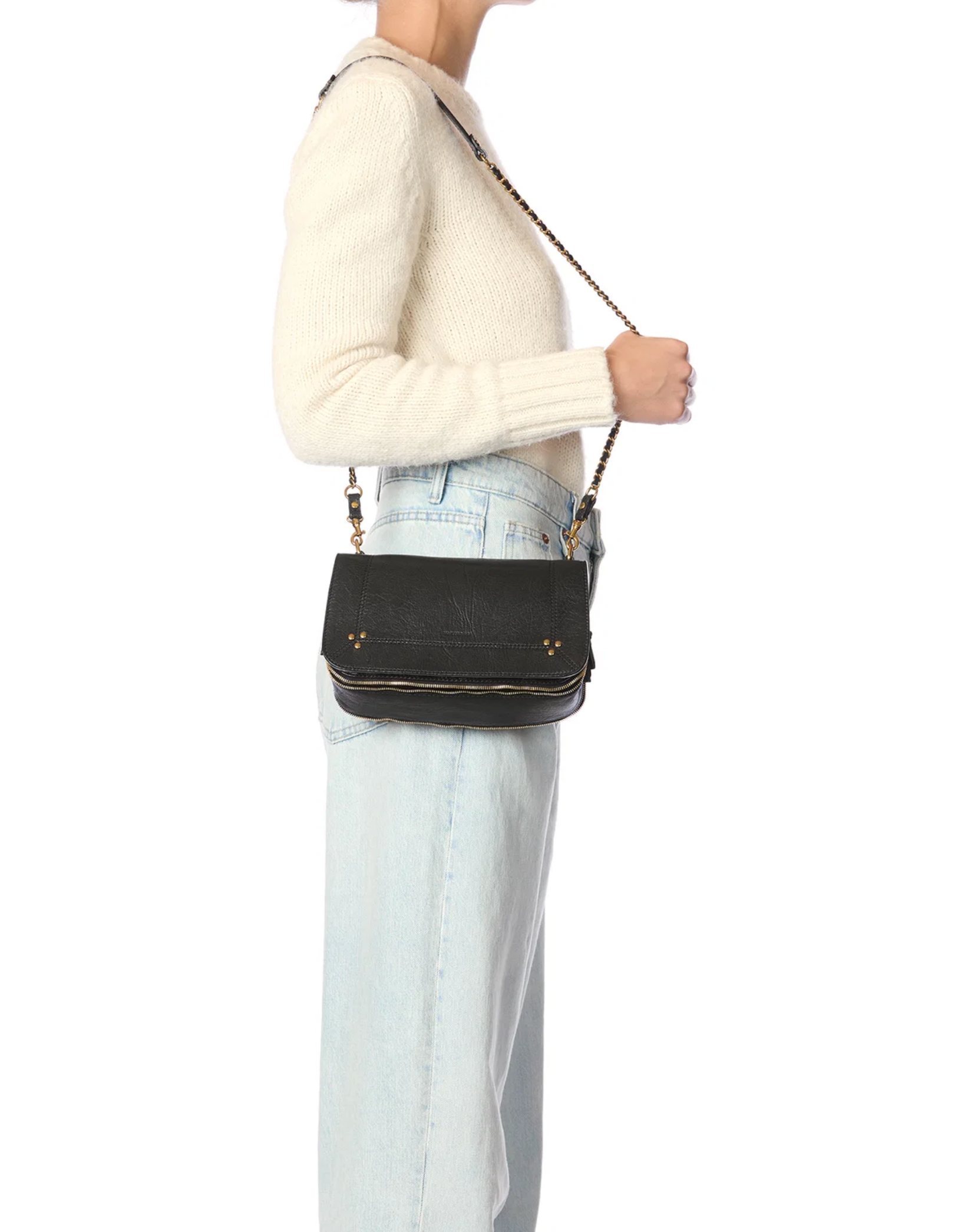 Jerome Dreyfuss Bobi small goatskin bag with adjustable chain strap styled with a white sweater and jeans.