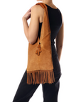 Jerome Dreyfuss Aram M Bag with tassel tie closure, carried by person in black, viewed from behind.