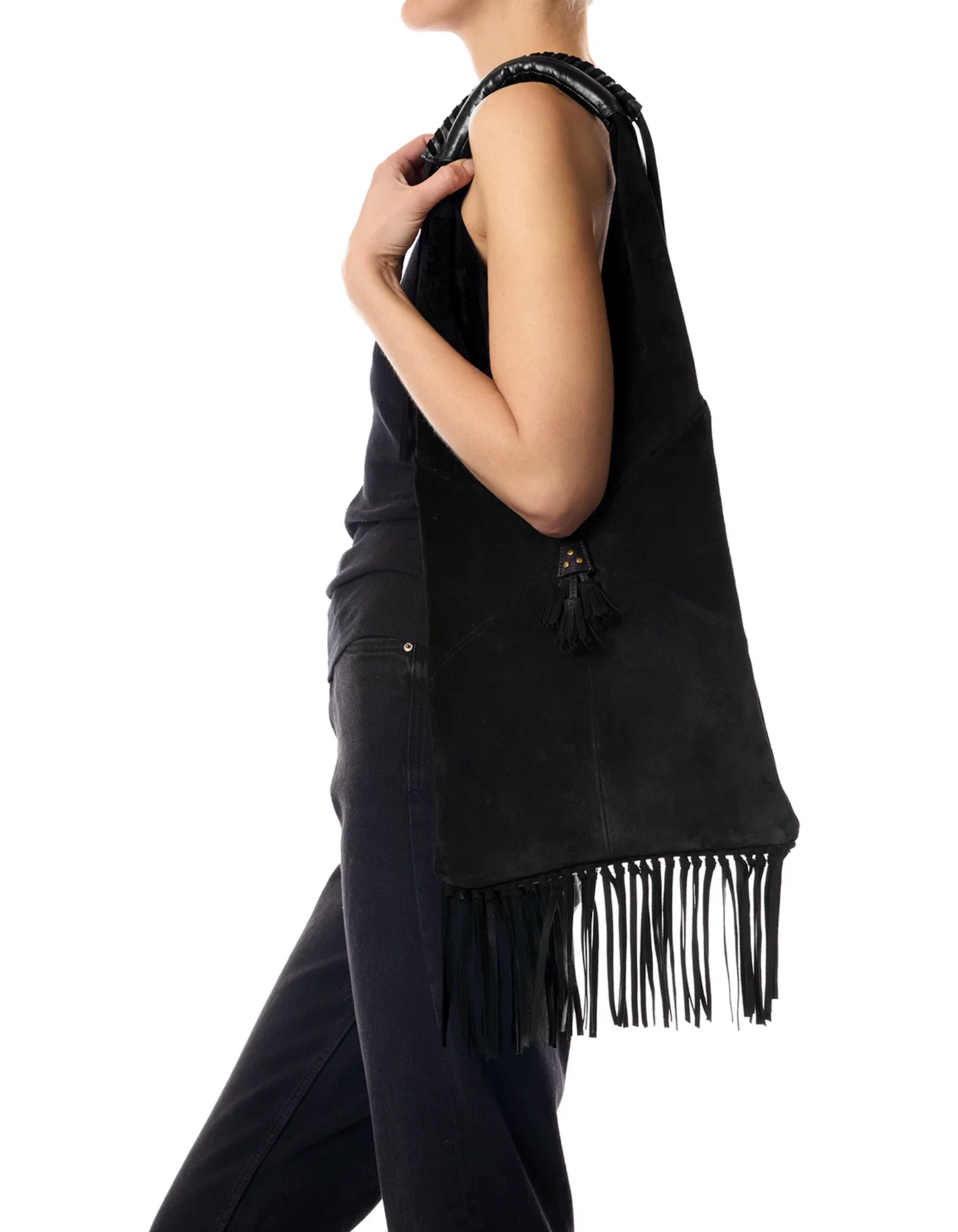 Jerome Dreyfuss Aram M Bag with tassel in black, styled over shoulder against a white background.