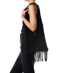 Jerome Dreyfuss Aram M Bag with tassel in black, styled over shoulder against a white background.