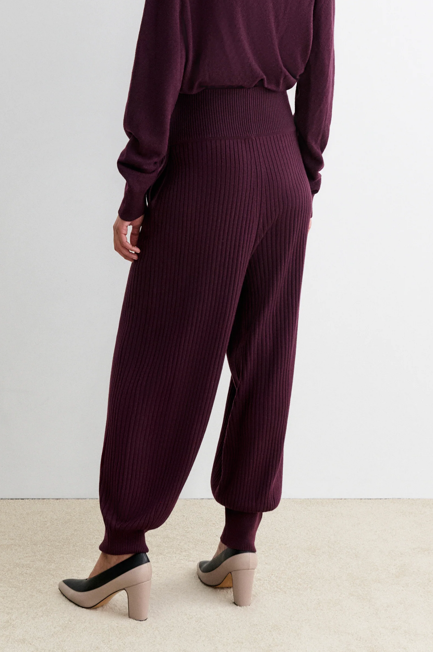 Rachel Comey Nim Pant and matching sweater in beige, styled with heels on a light carpet for a cozy look.