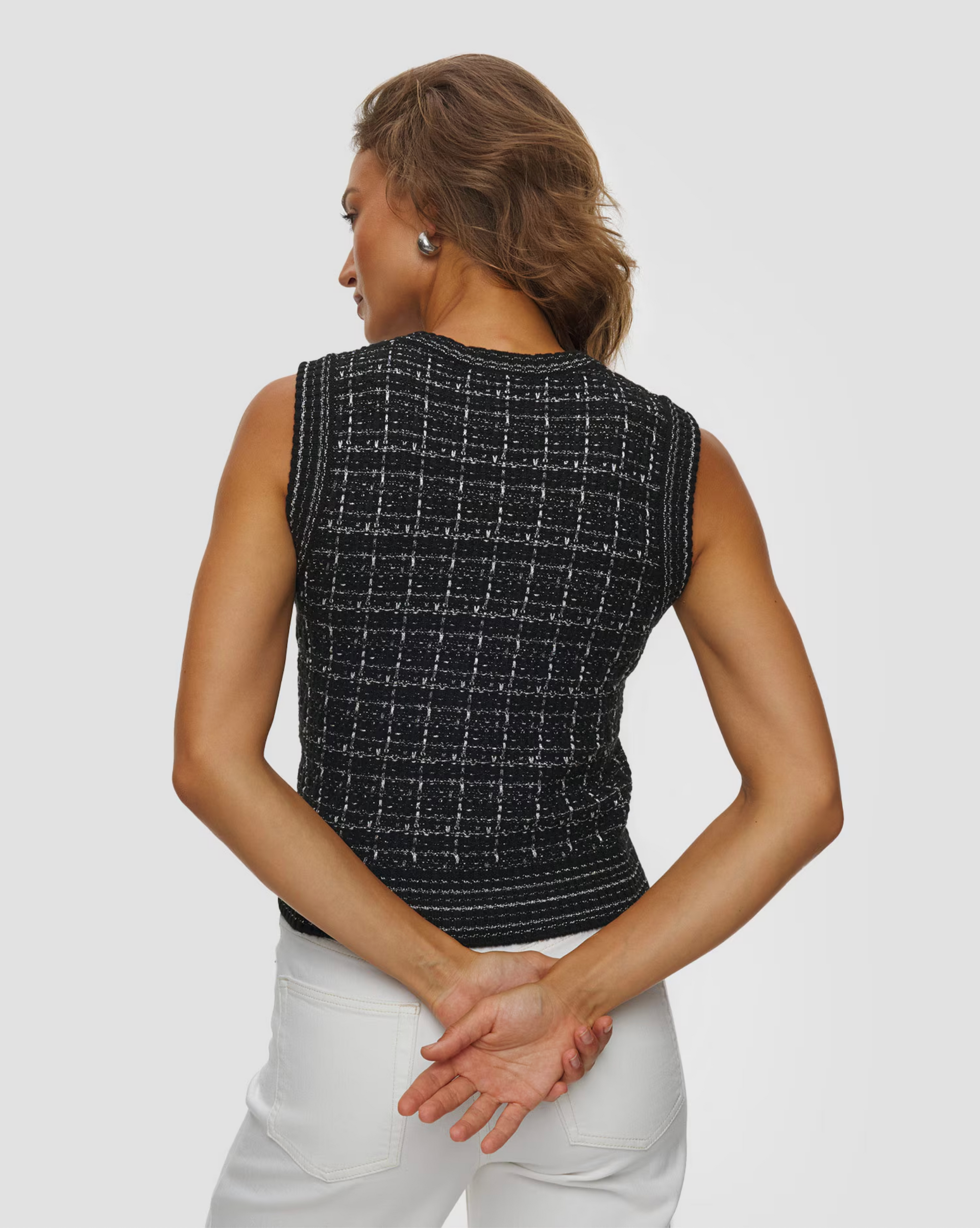 Sleeveless KUJTEN Gia Tweed top and white pants seen from the back, relaxed style, neutral setting.