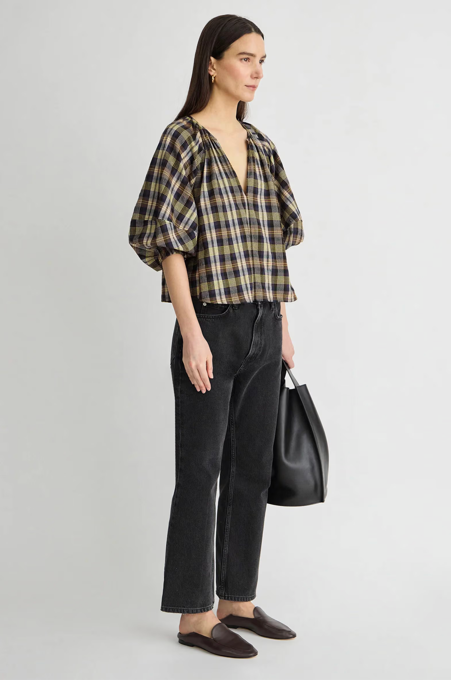 Apiece Apart Nele Lantern Sleeve Top styled with black jeans and loafers, casual modern look, side profile view.