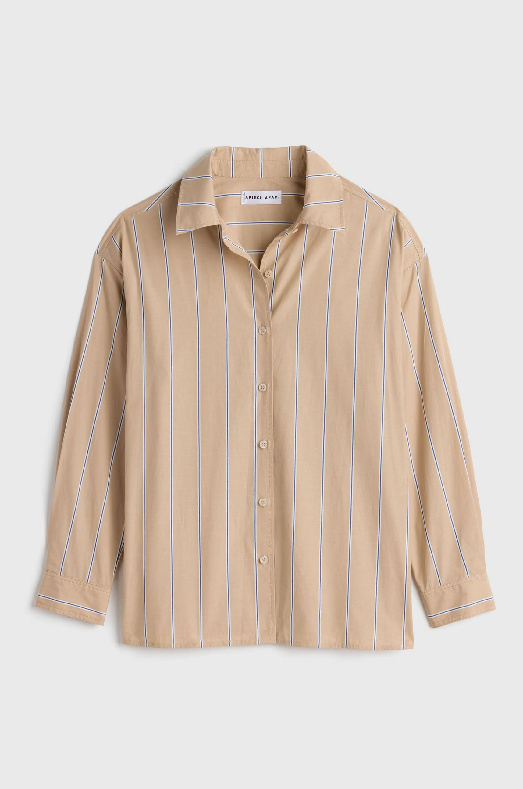 Oversized beige cotton button-down with blue and white stripes by Apiece Apart, long sleeves, relaxed fit.
