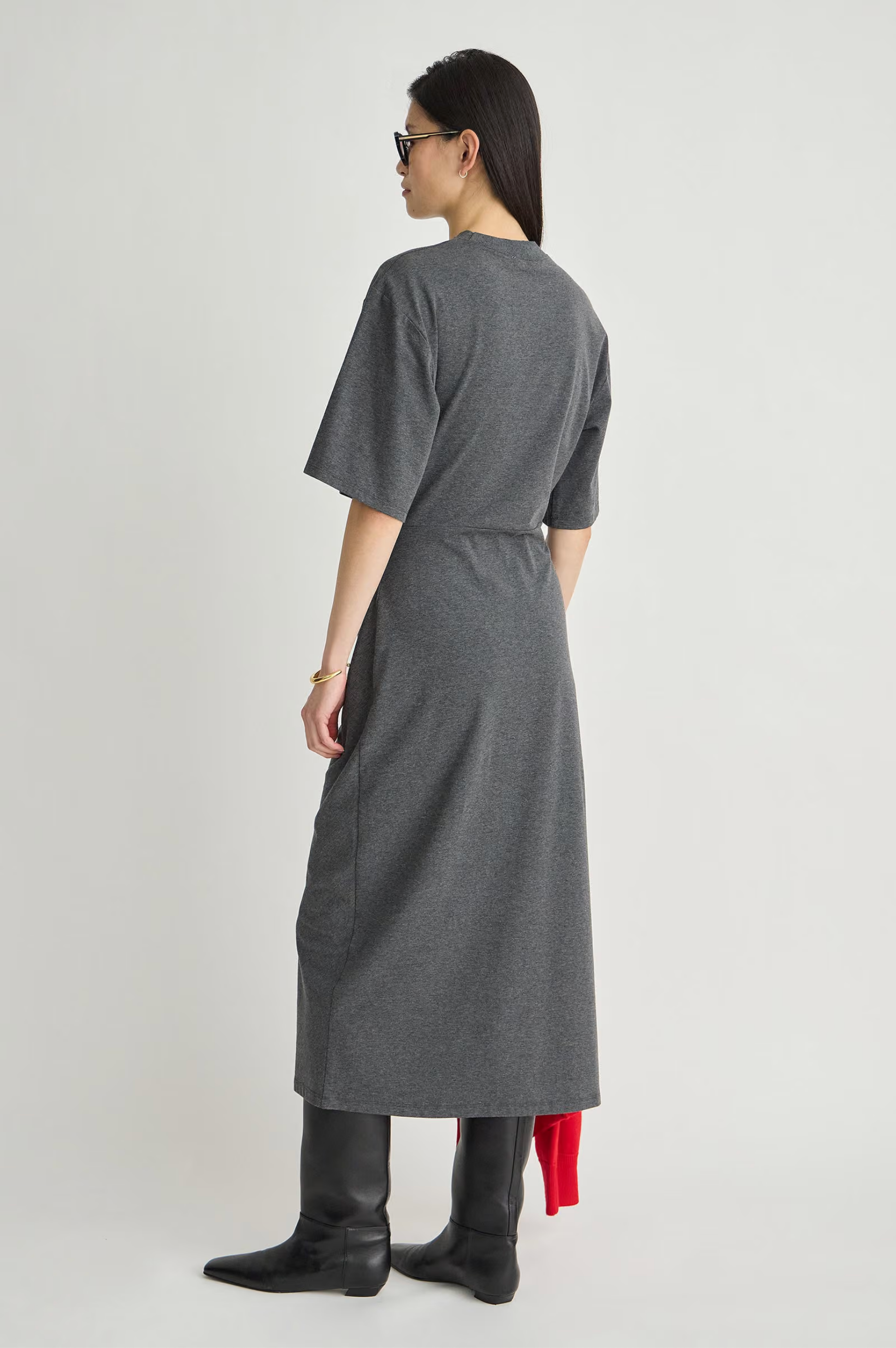 Apiece Apart Luna Cinched Maxi dress in black, shown from the back with black boots for a modern, elevated look.