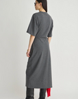 Apiece Apart Luna Cinched Maxi dress in black, shown from the back with black boots for a modern, elevated look.