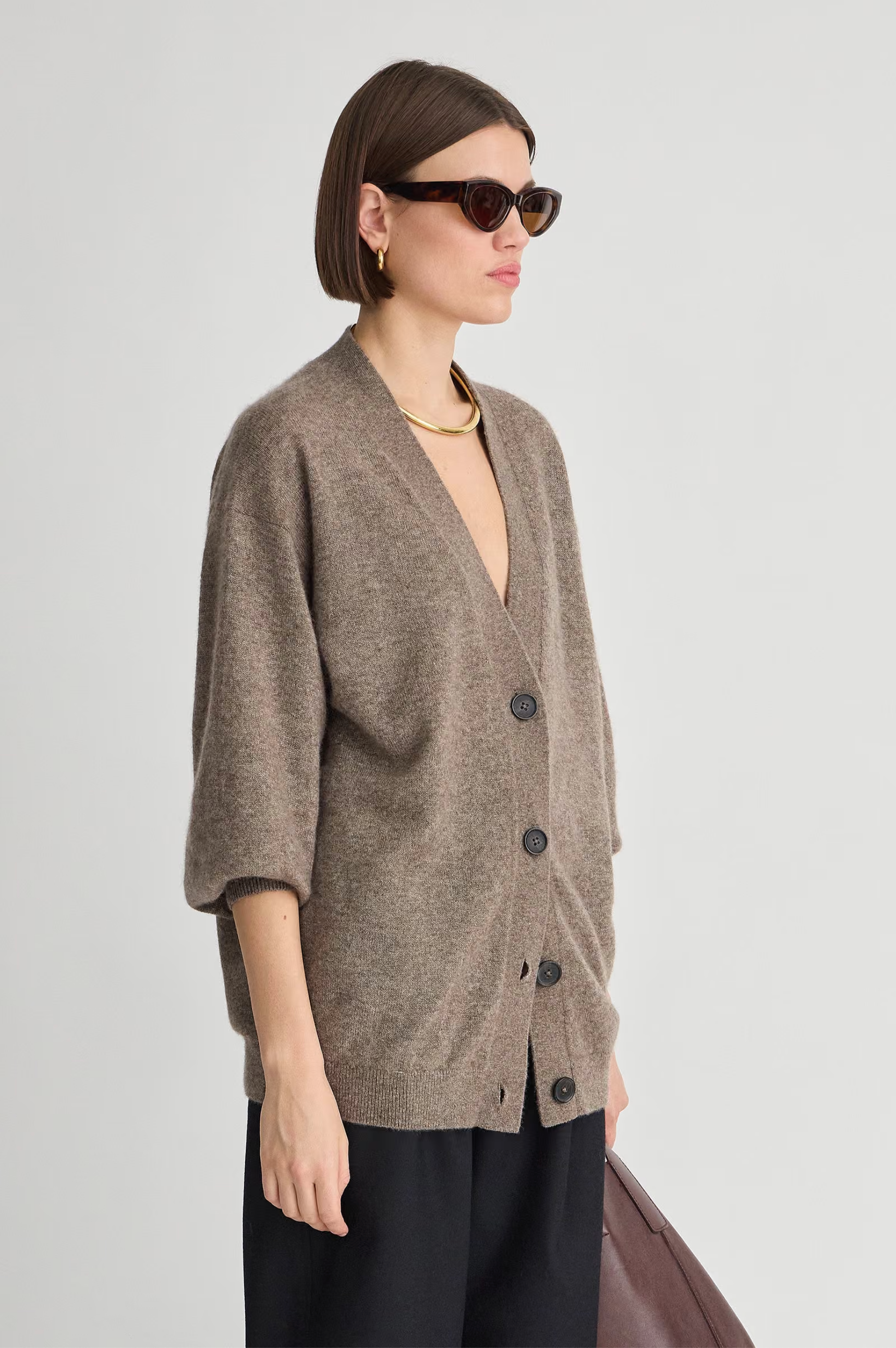 Soft knit Apiece Apart cardigan styled with sunglasses and gold jewelry, Bungalow Furniture &amp; Accessories.