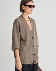 Soft knit Apiece Apart cardigan styled with sunglasses and gold jewelry, Bungalow Furniture & Accessories.