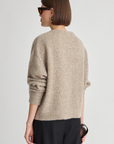 Apiece Apart Softest Silk Cashmere V-Neck Marl sweater in black, styled with sunglasses and black pants.