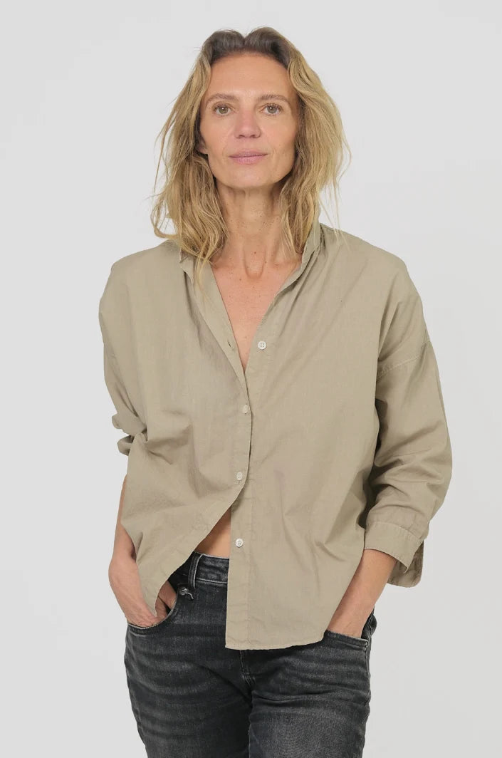 Monday12 Zoe Shirt in Army Beige styled with black jeans, worn by a woman with wavy blonde hair against a light background.